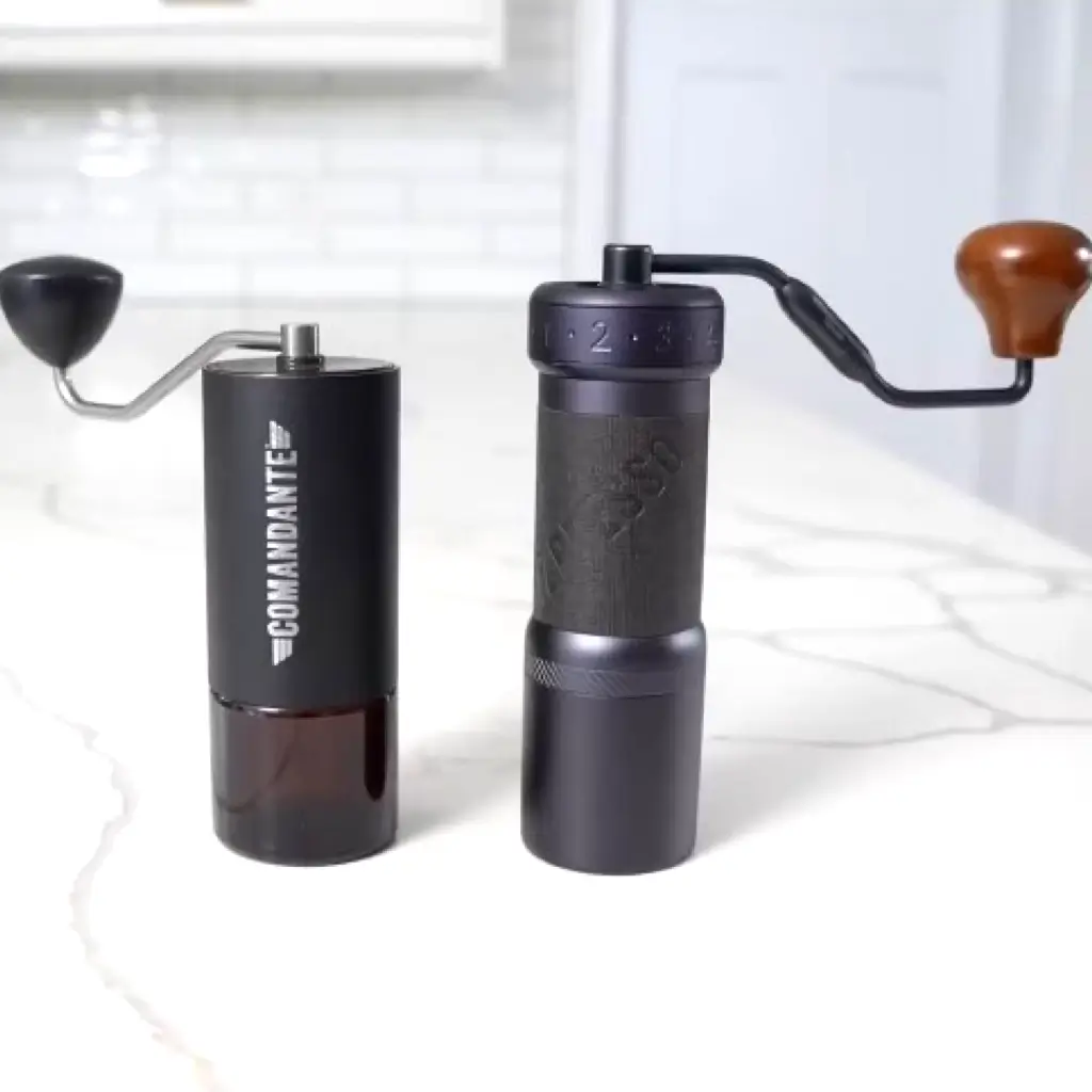 Comandante and 1Zpresso manual coffee grinders side-by-side comparison showing design differences and handle styles