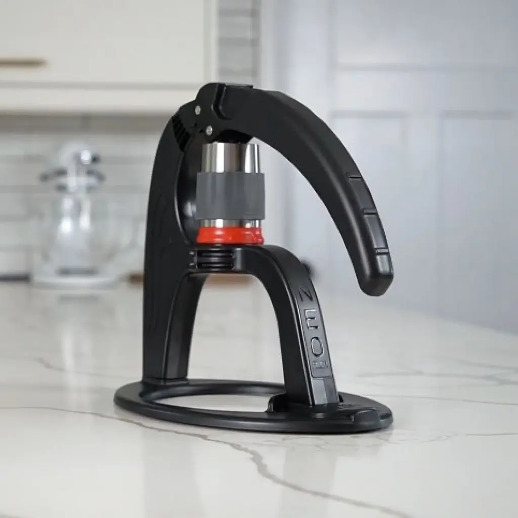 Flair NEO Flex manual espresso machine with black frame and red silicone gasket on white marble countertop