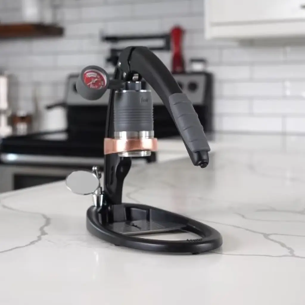 Manual espresso machine Flair PRO 3 with pressure gauge on marble countertop in modern kitchen