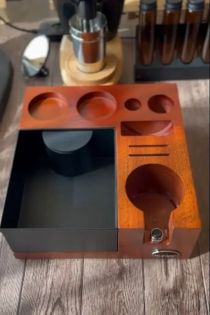 IKAPE V2 Espresso Knock Box and Organizer Station in warm walnut wood finish with dedicated slots for espresso tools including tamper, distributor, and dosing cup, alongside a matte black puck drawer β a complete espresso workspace organizer.